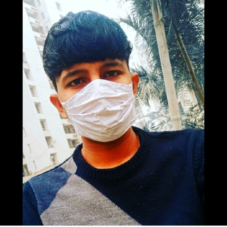 A young man wearing a surgical mask.